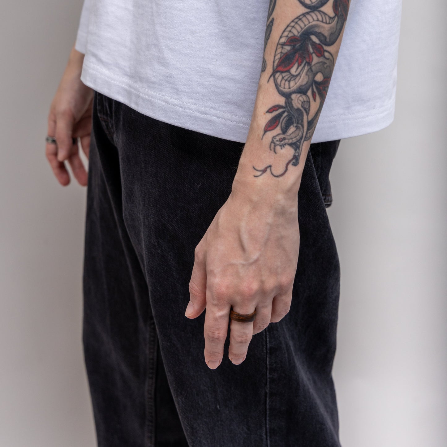 LinkRing Balance sandalwood lookbook photo, worn by model with a white T shirt and black jeans, on a bright background