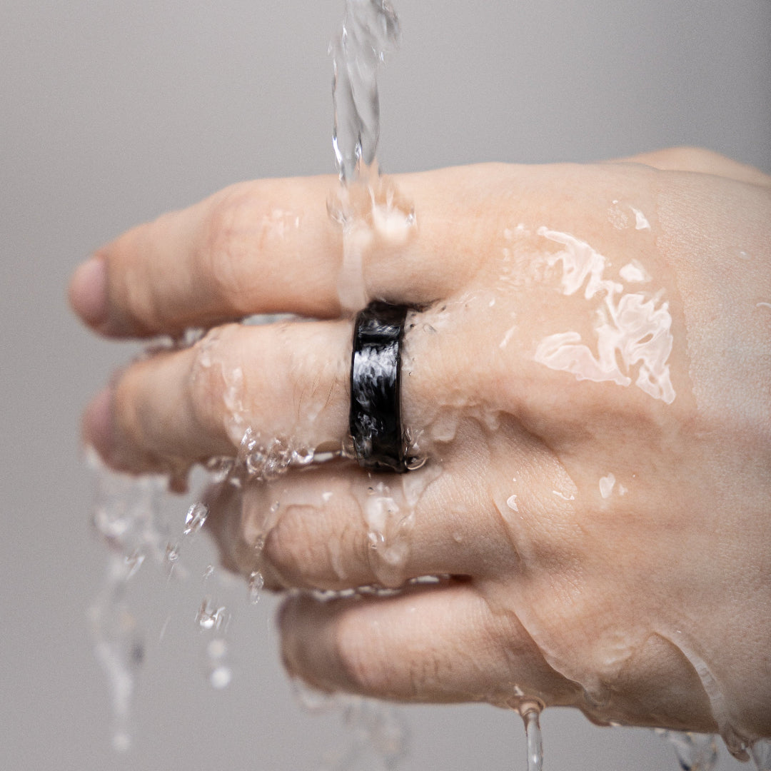 Model hand under running water, wearing a LinkRing Prestige to show that it's waterproof
